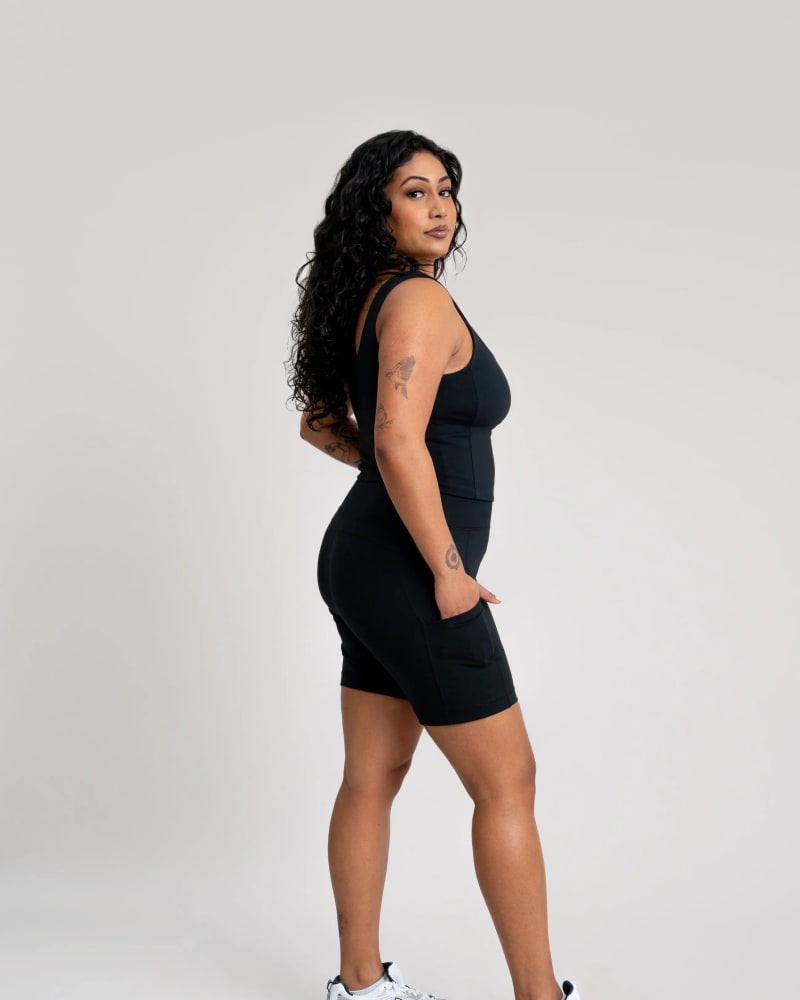 Side of a model wearing a size XL adventure performance bike shorts in black by alder apparel. | dia_product_style_image_id:296234